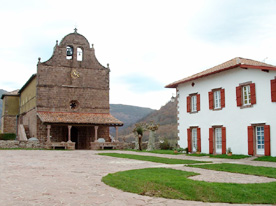 La place de l'église, dominée par le clocher-mur en forme de fronton, ouvre sur un superbe panorama sur la chaine des Pyrénées